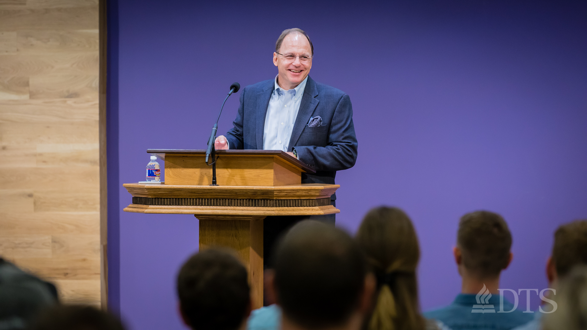 man standing at podium speaking at DTS Chapel