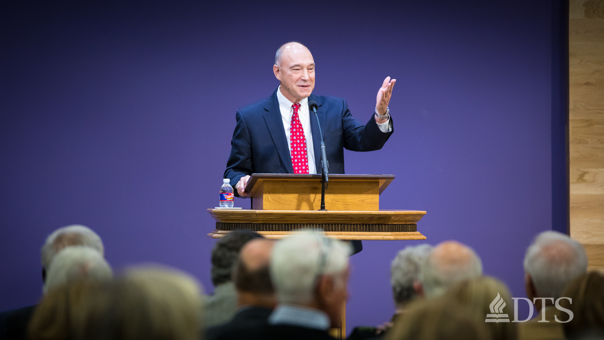 man standing at podium speaking at DTS Chapel