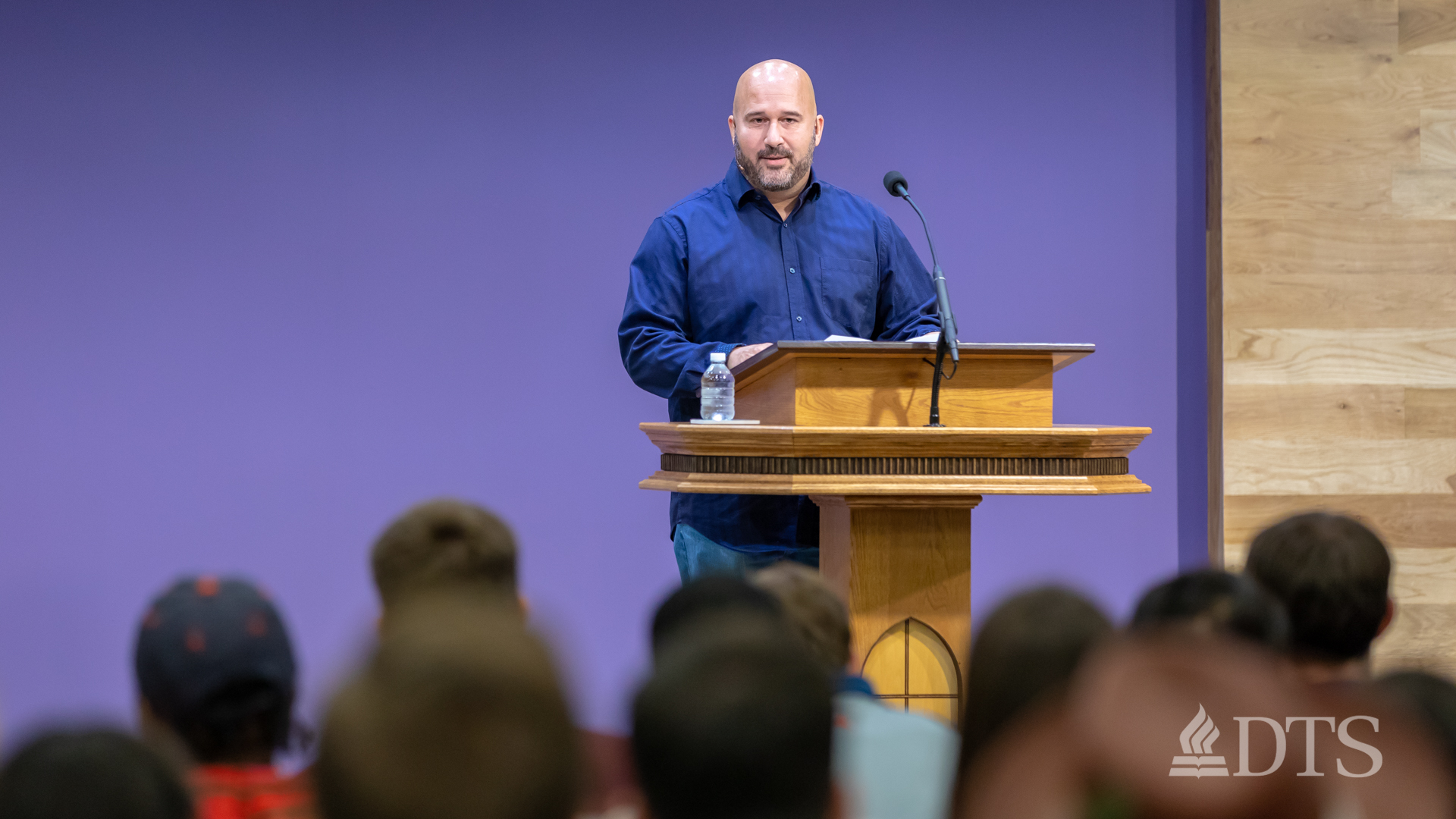 man standing at podium speaking at DTS Chapel