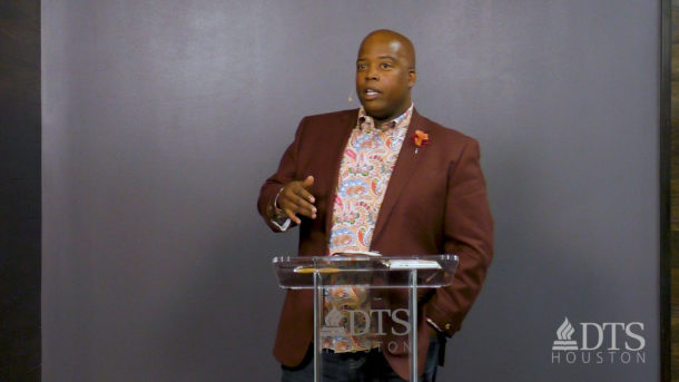 man standing at podium speaking at DTS Chapel