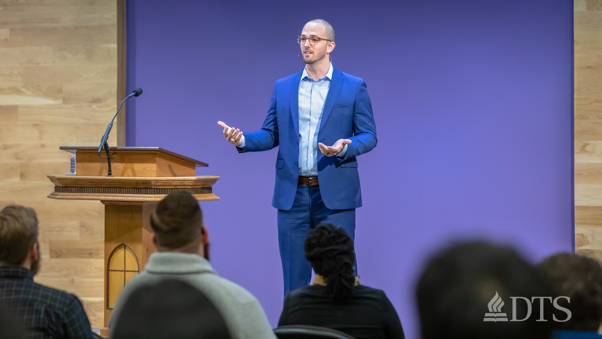 man standing near podium speaking at DTS Chapel