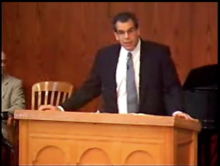 man standing at podium speaking at DTS Chapel