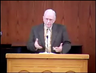 man standing at podium speaking at DTS Chapel