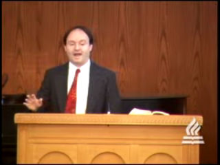 man standing at podium speaking at DTS Chapel