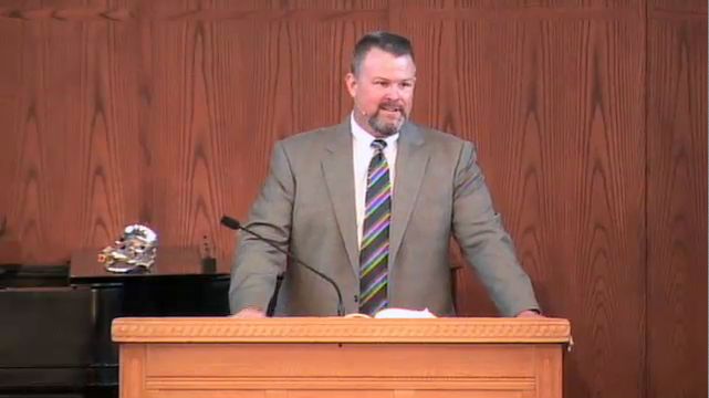 man standing at podium speaking at DTS Chapel