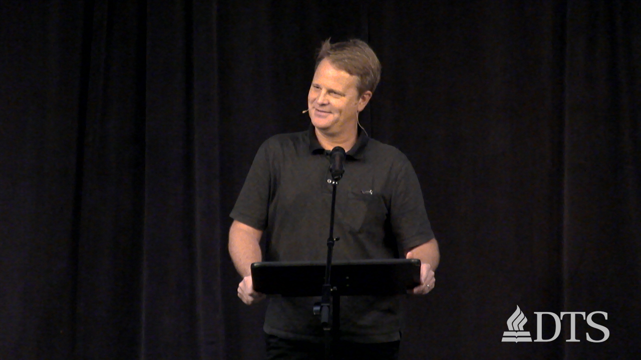 man standing at podium speaking at DTS Chapel