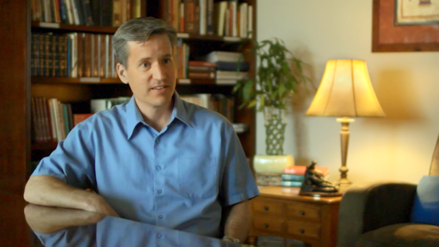 Brad Hopkins seated at a table in conversation