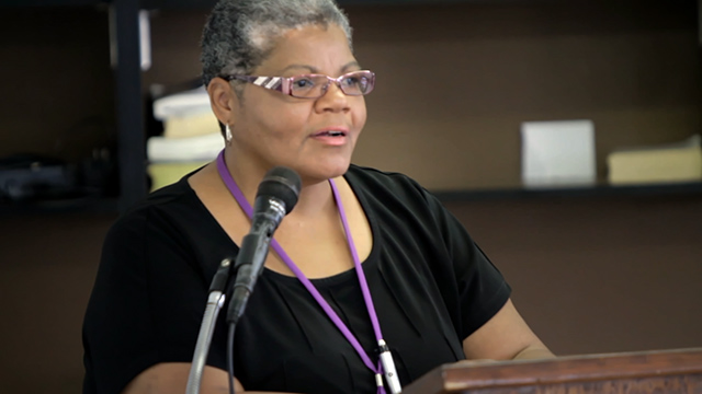 DTS alum Lettie Watkins speaking at a podium